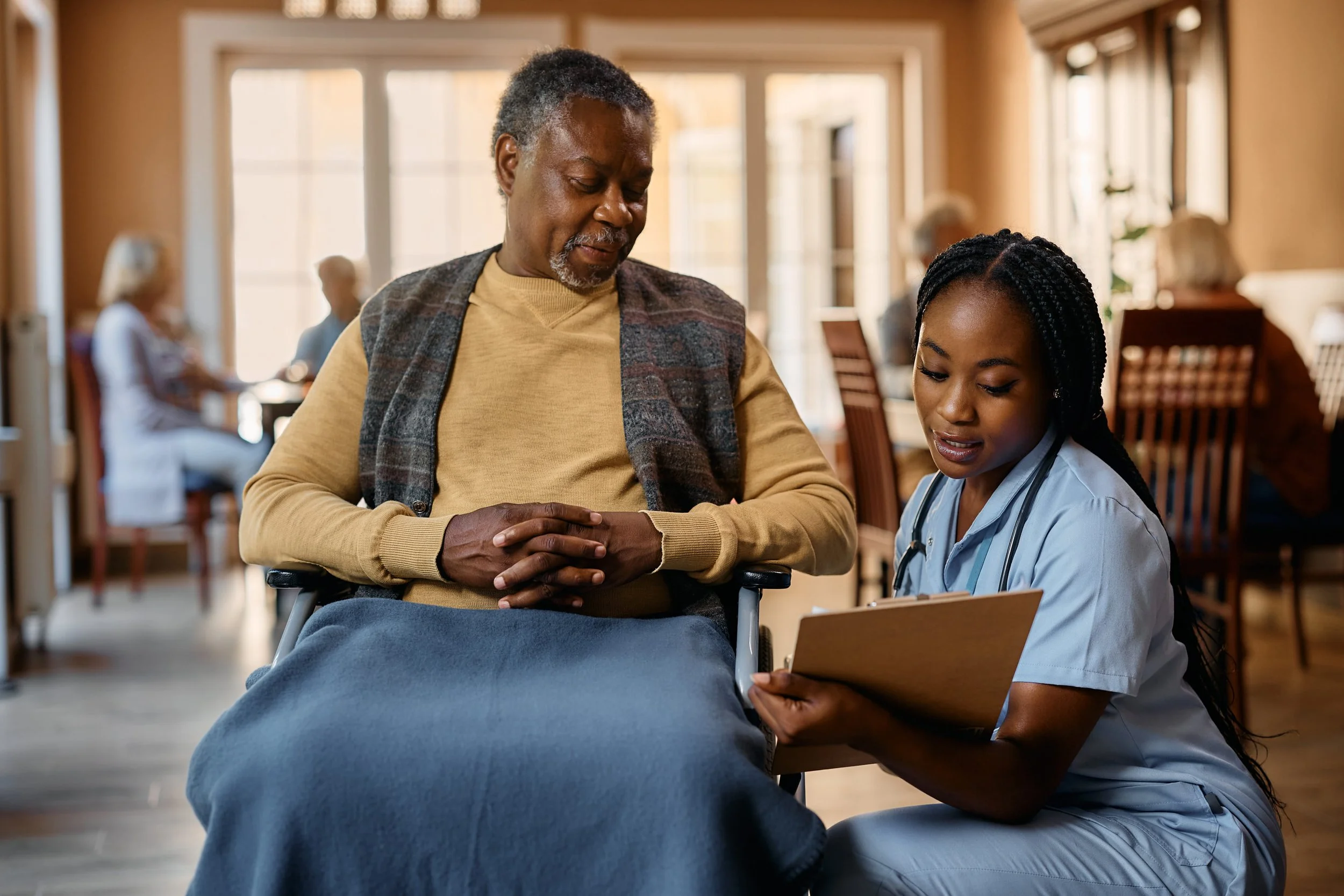 TBI resident receiving daily living support from a caregiver in a Medical Alternatives group home in Southeast Michigan