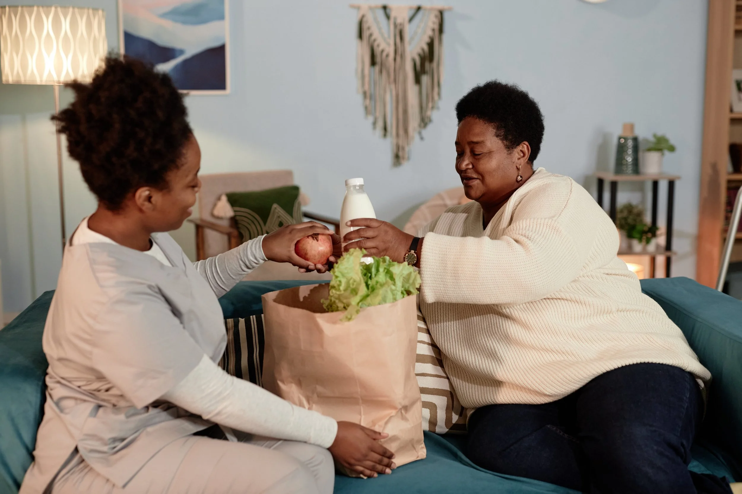 Smiling direct support staff caregiver in scrubs at Medical Alternatives Inc. in Novi, Michigan