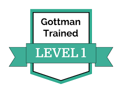 Regenerate alt text copyIconcrossIconBlue Shield badge with Gottman Trained at top and a ribbon across center reading LEVEL 1 in bold white letters.