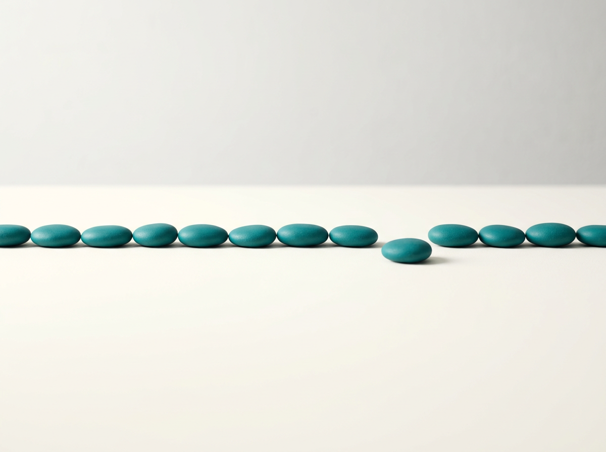 Bookkeeping: A straight row of teal stones on an ivory surface
