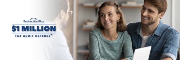 A smiling woman and man sitting across from an auditor at a desk, discussing tax audit defense, with a sign indicating $1 million tax audit defense protection.