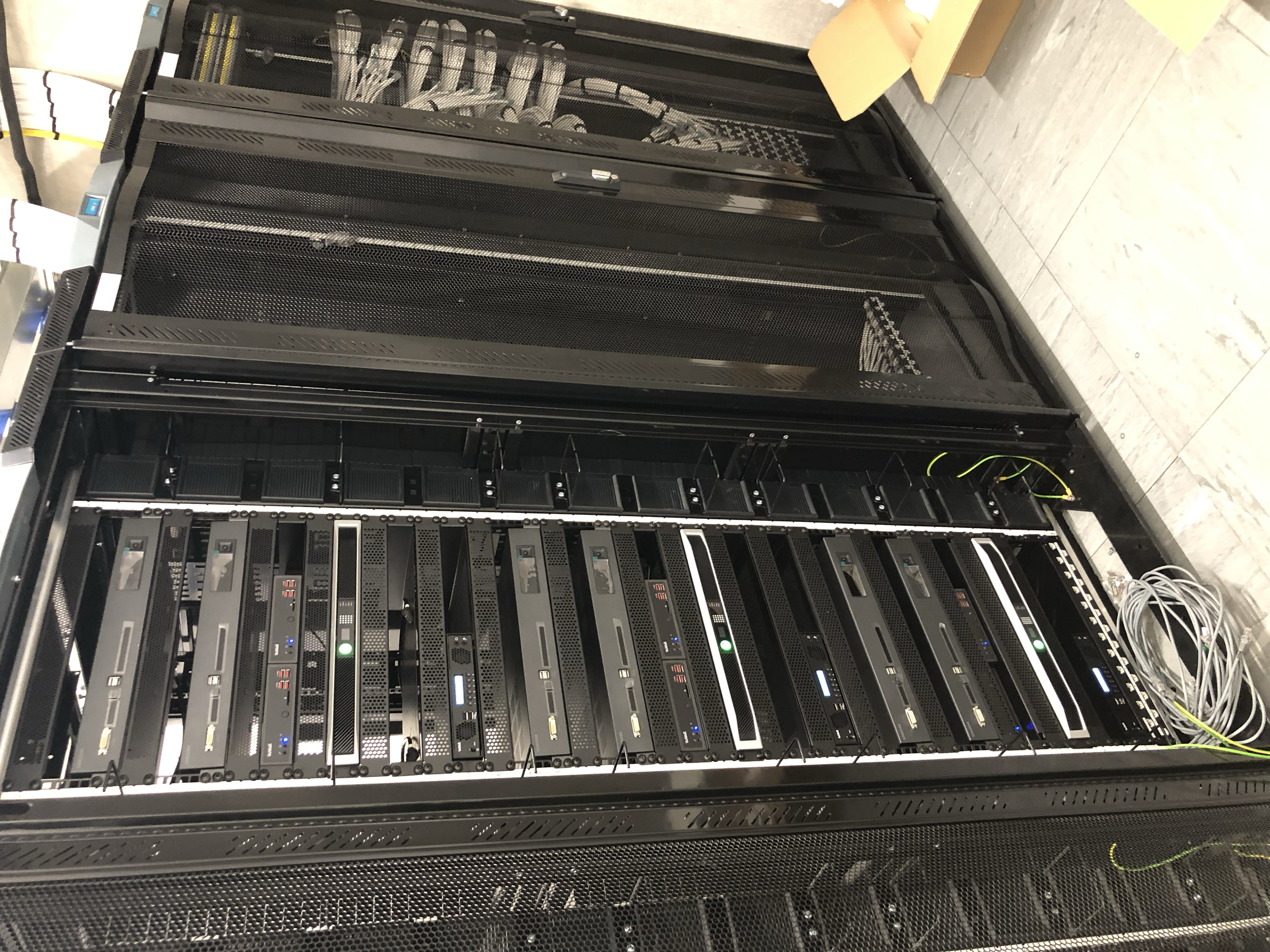 A server rack with multiple server units inside a data center or server room.