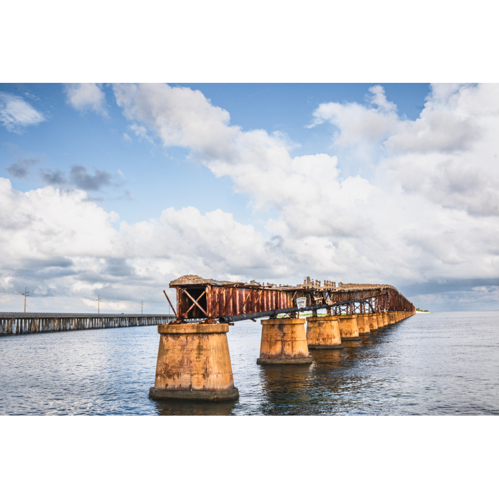 Historic Bahia Honda Bridge stretching across calm ocean water.