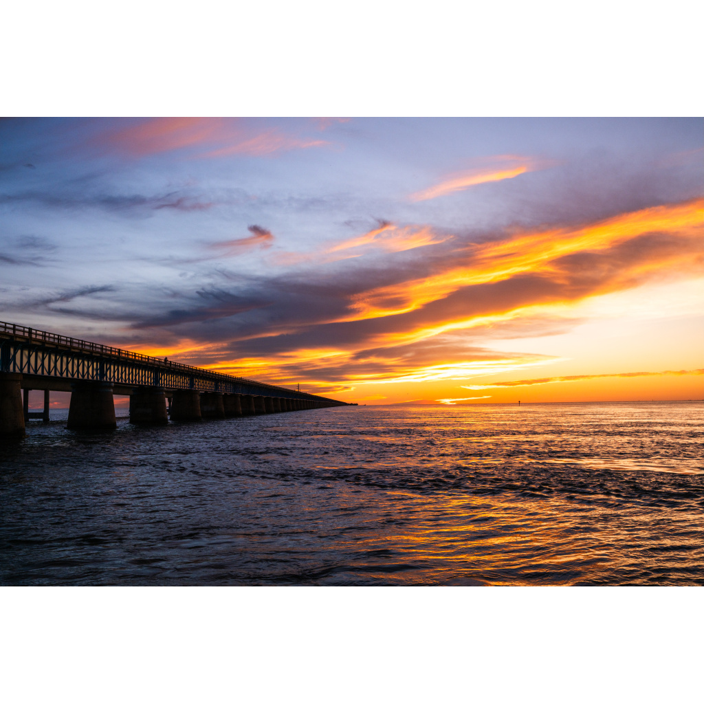 Seven Mile Bridge at dusk beneath a dramatic sunset sky in the Florida Keys.