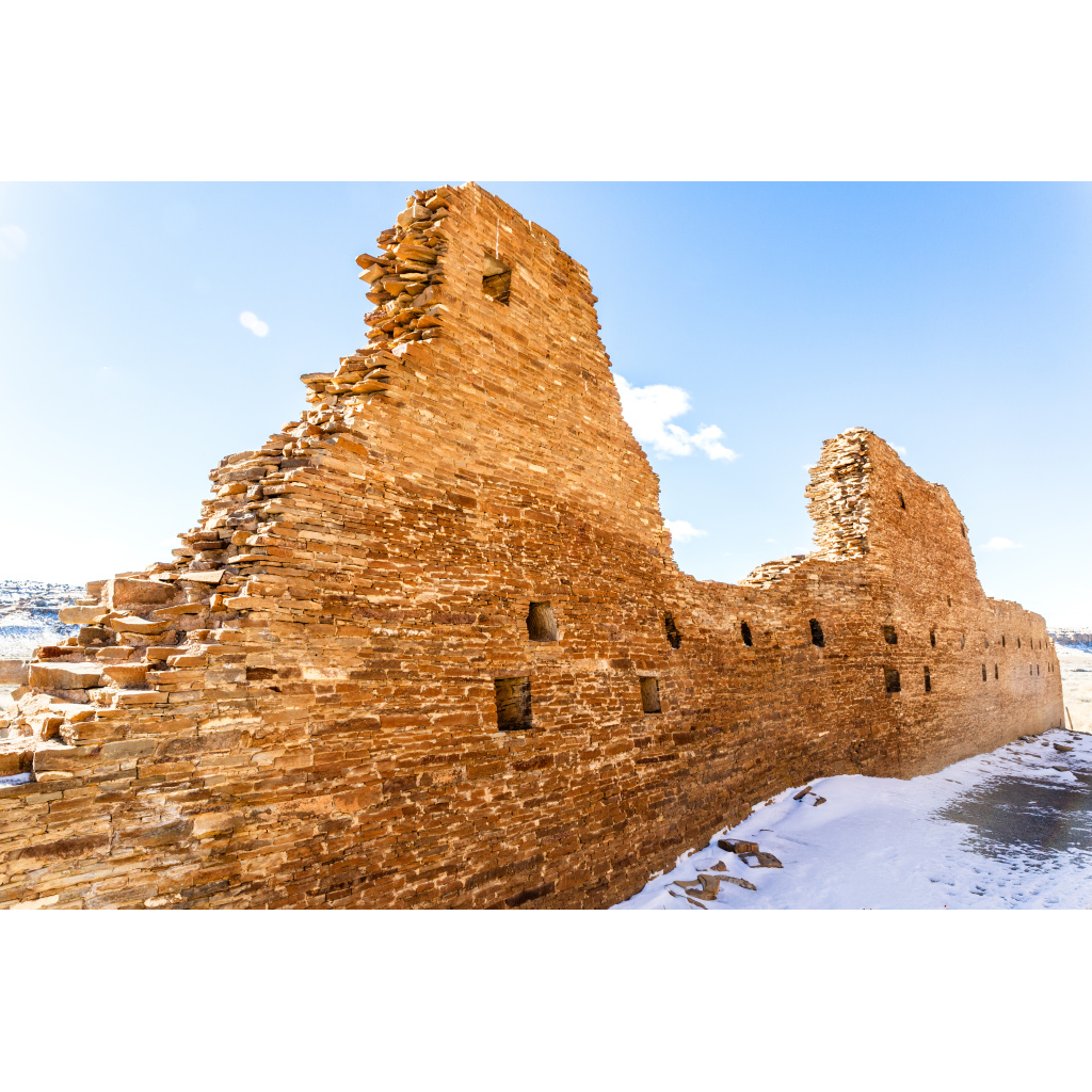 Detailed view of ancient stone walls and structures in Chaco Canyon under bright desert light.