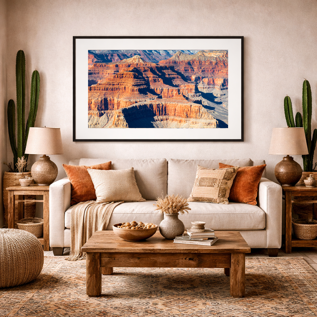 Grand Canyon landscape fine art print displayed in a warm, desert-inspired living room interior.