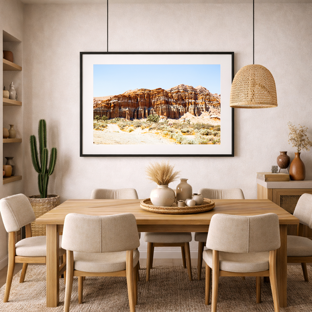 Southwest red rock cliff fine art print displayed in a warm, desert-inspired living room interior.