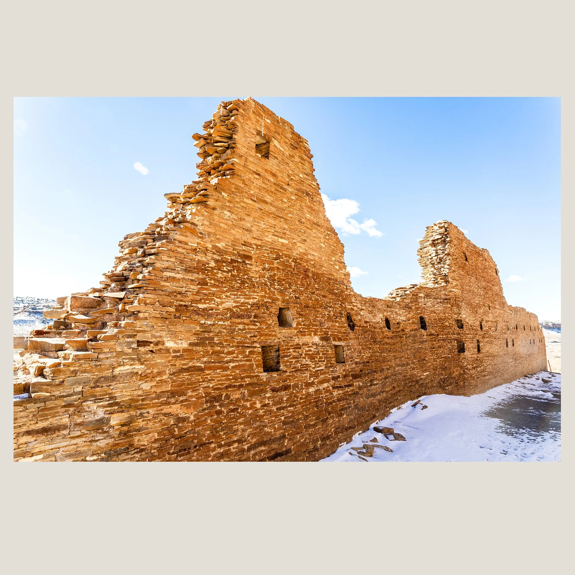 Ancient stone walls and architectural remains of Chaco Canyon beneath a clear New Mexico sky.