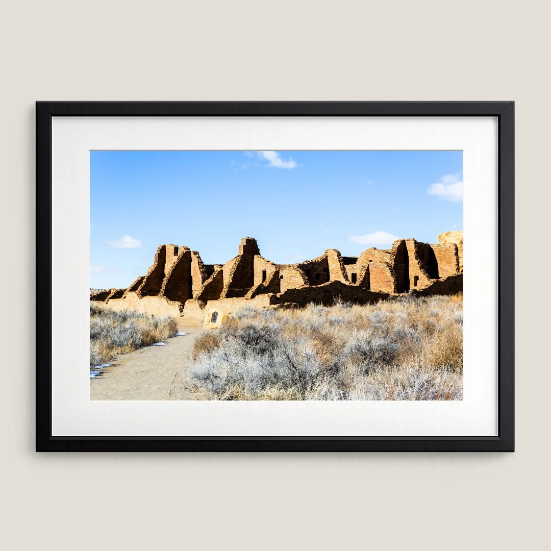 Framed Chaco Canyon ruins print with black frame and white mat, featuring ancient stone structures in New Mexico.