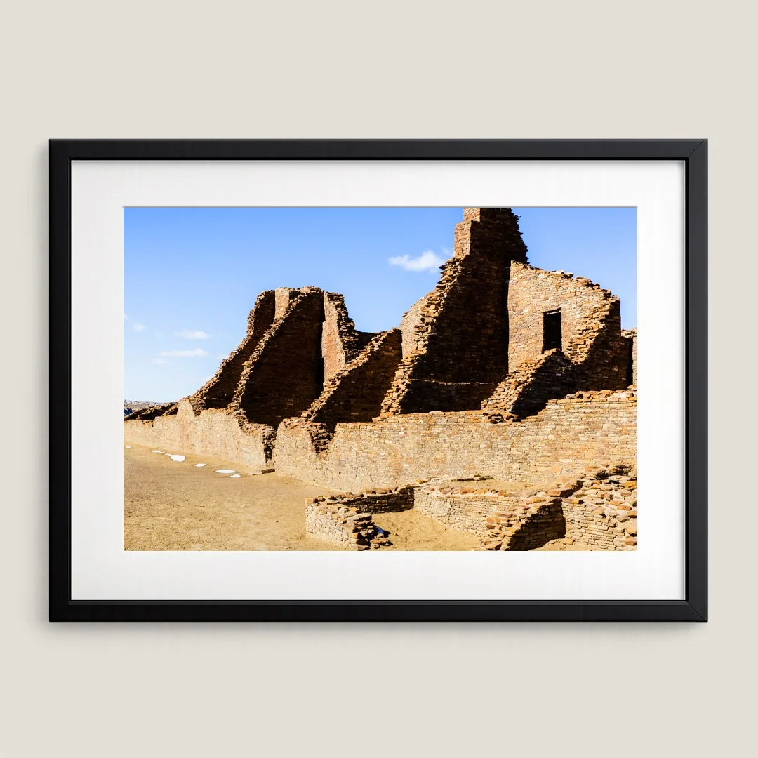 Framed New Mexico ruins print with black frame and white mat, featuring historic Chaco Canyon stone structures.