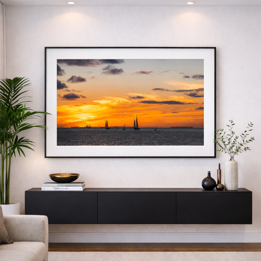 Framed Key West sailboat sunset print styled in a luxury coastal living room.