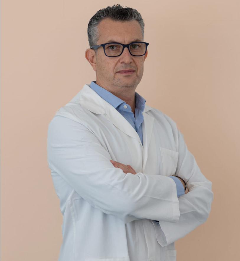 uomo medico con occhiali da vista, capelli grigi, camice bianco, fondo beige