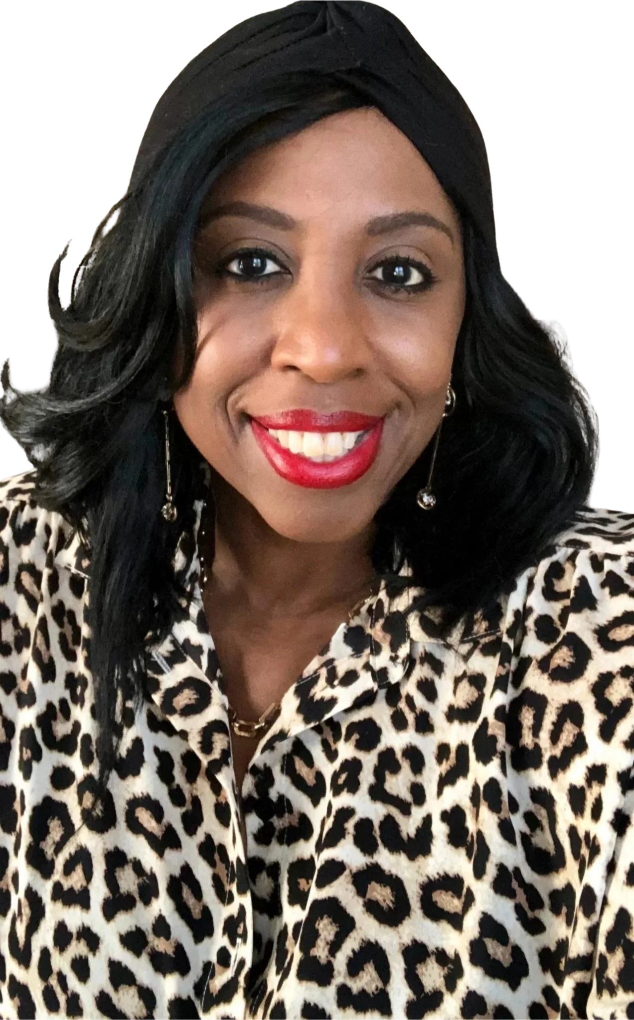 A woman named Arletta smiling, wearing red lipstick, black wavy hair, leopard print blouse, gold necklace, and dangling earrings.