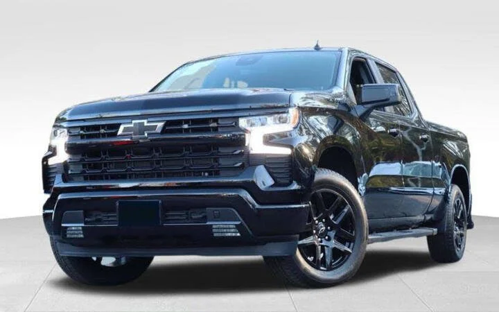 Black Chevrolet pickup truck, front side view on light background.