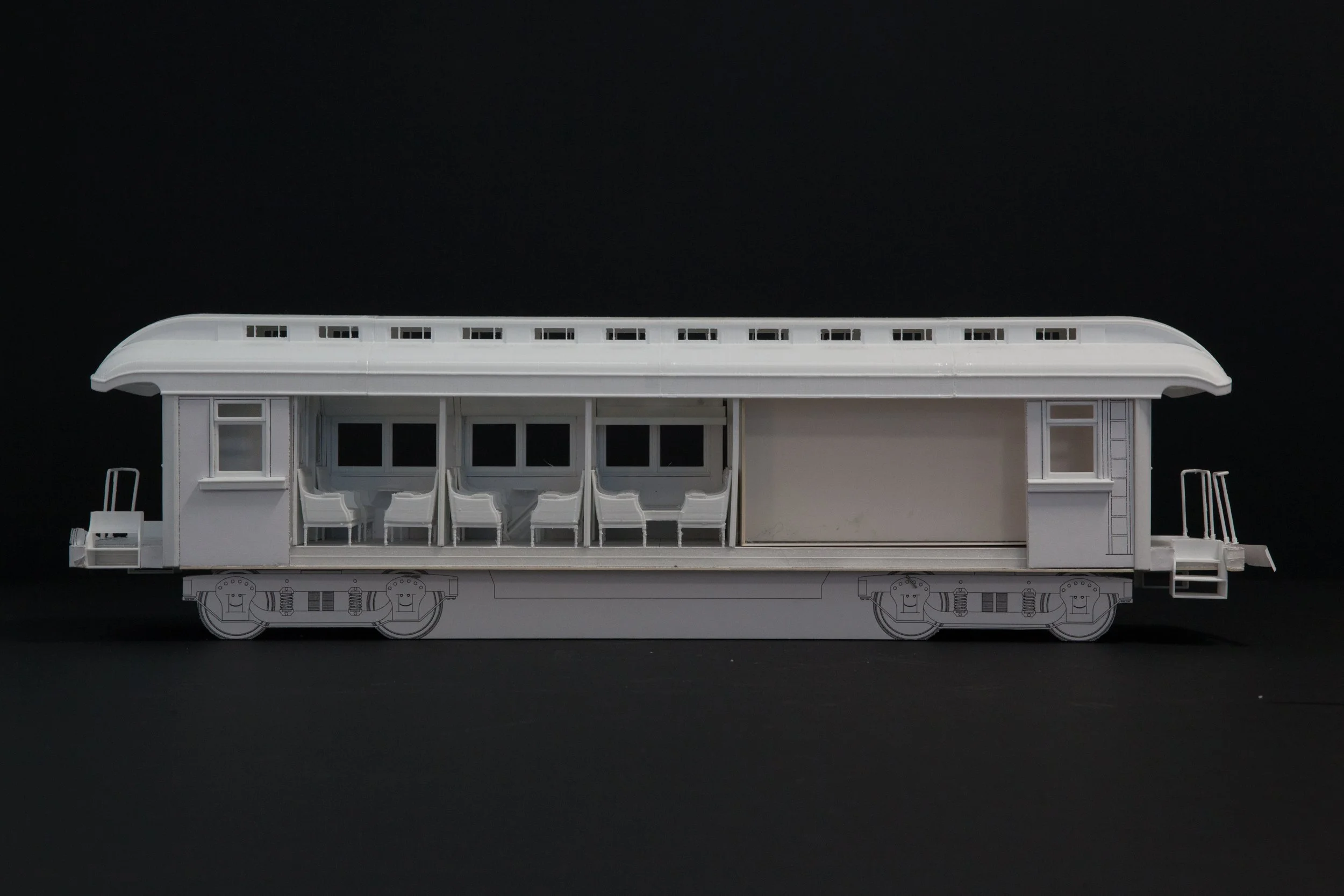 White model train car with detailed interior and exterior, placed against a black background.