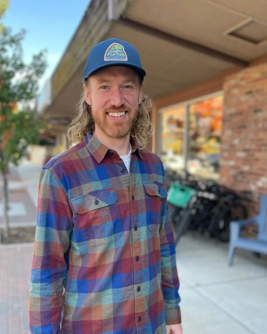 Smiling Sales Associate outside the OE Shop