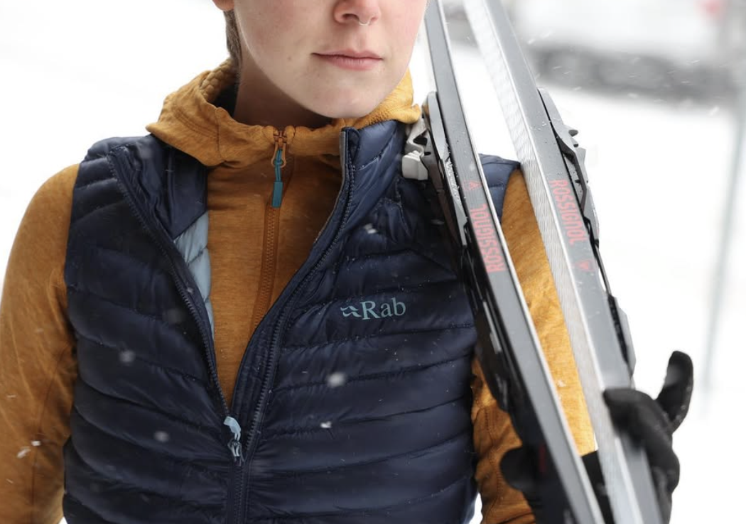 Woman in Rab vest holding Rossignol skis in Sandpoint, Idaho