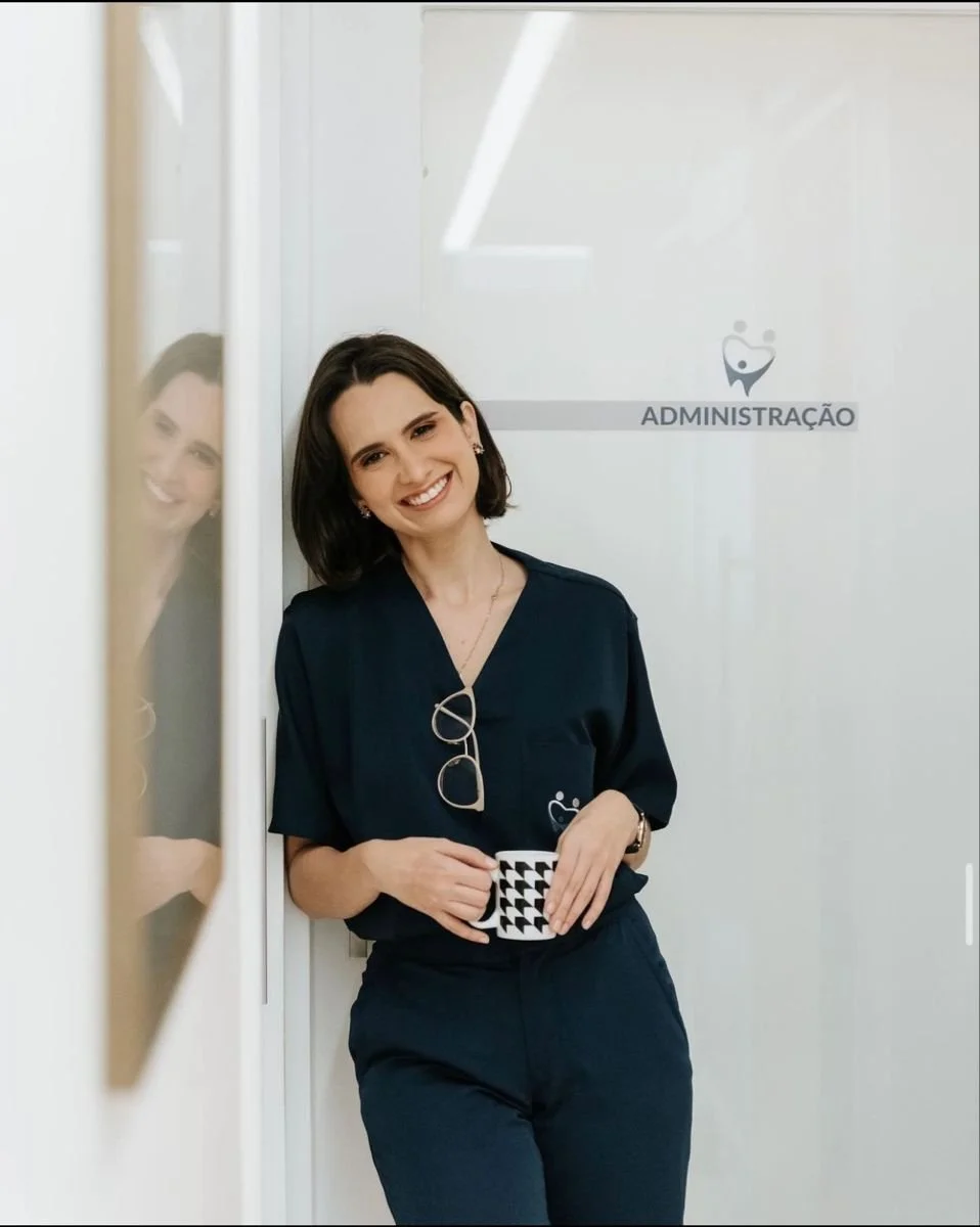 A woman holding her cup smiling