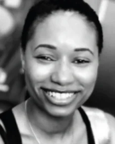 Smiling young woman with short hair, captured in black and white.