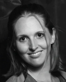 Black and white portrait of a smiling woman with shoulder-length hair
