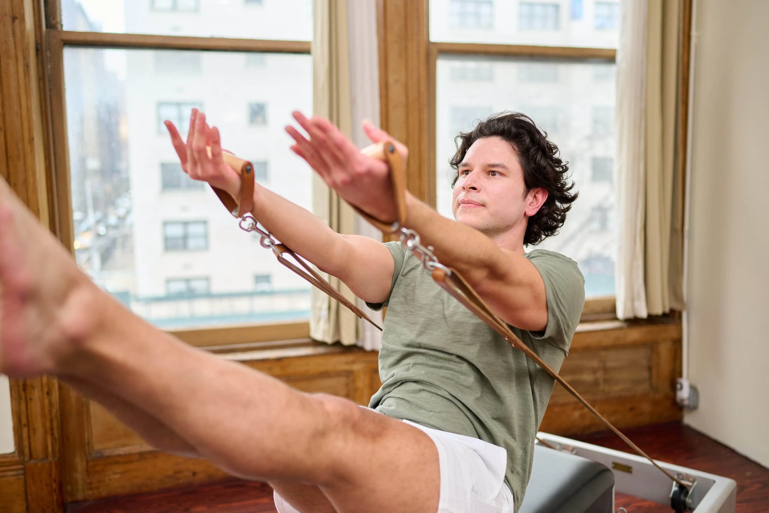 Pilates instructor on reformer working with precision and focus