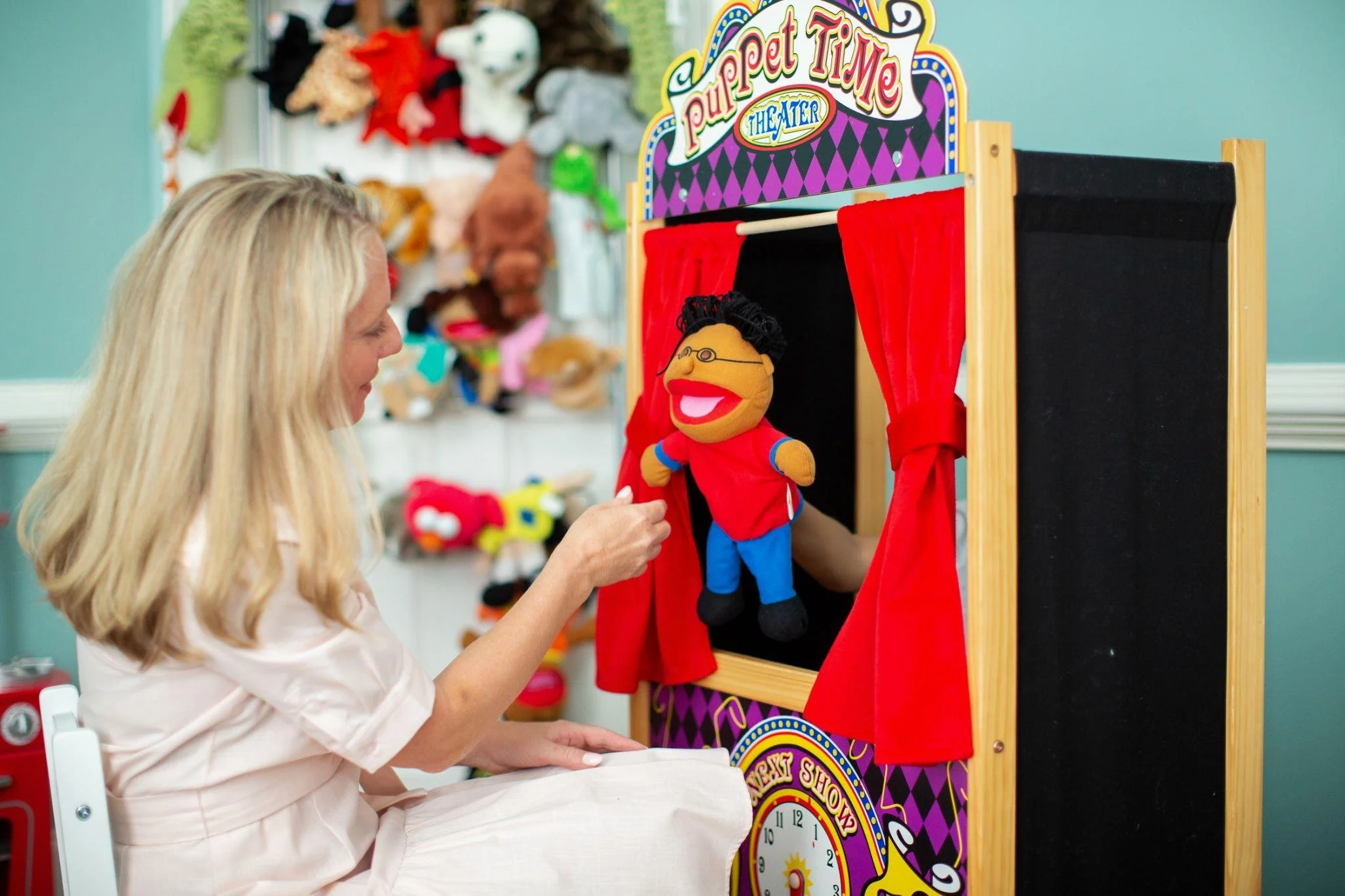 woman playing with a puppet show