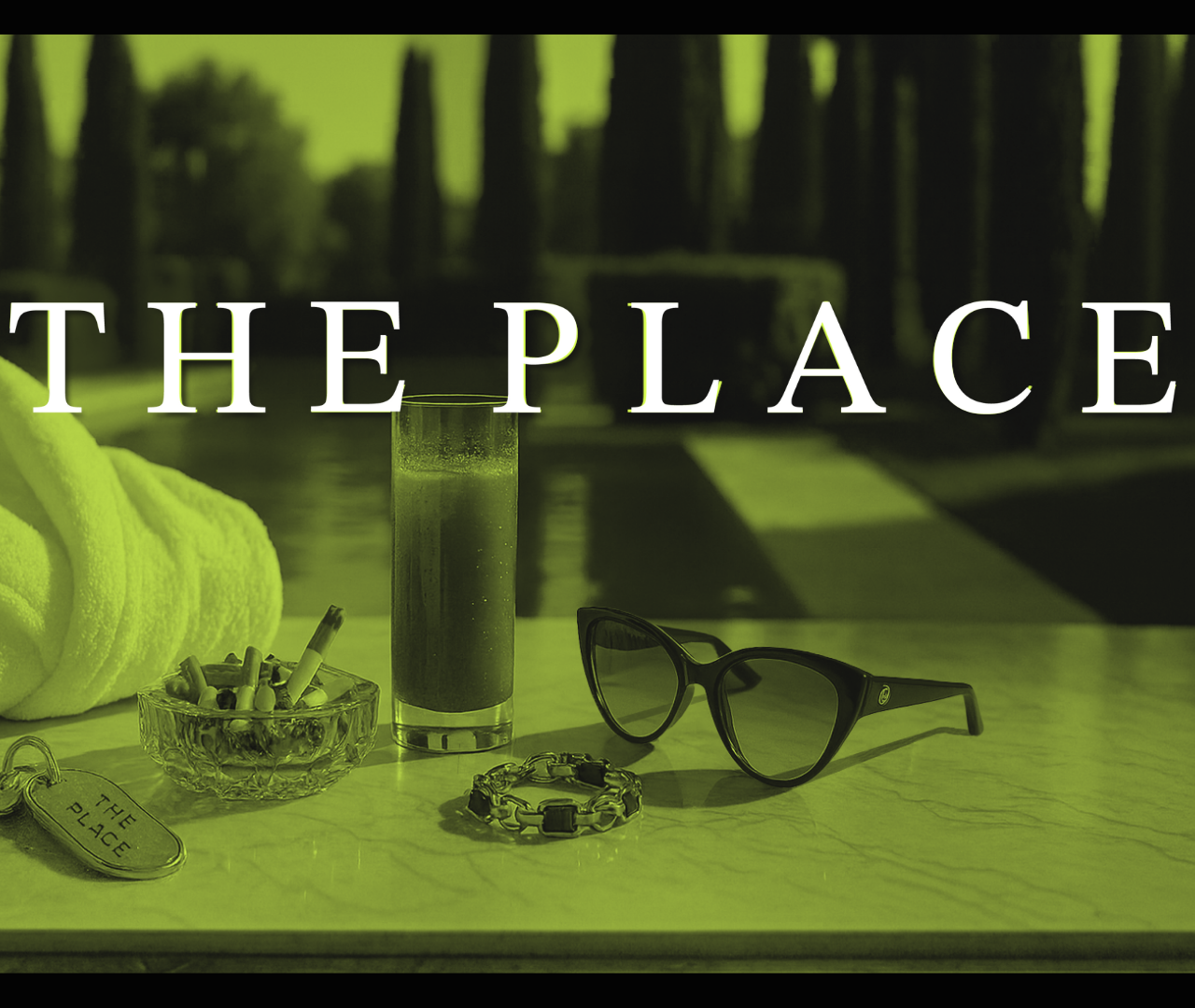 Items on a table including a towel, ashtray, bracelet, glasses, and a drink, with the text "The Place" overlayed.