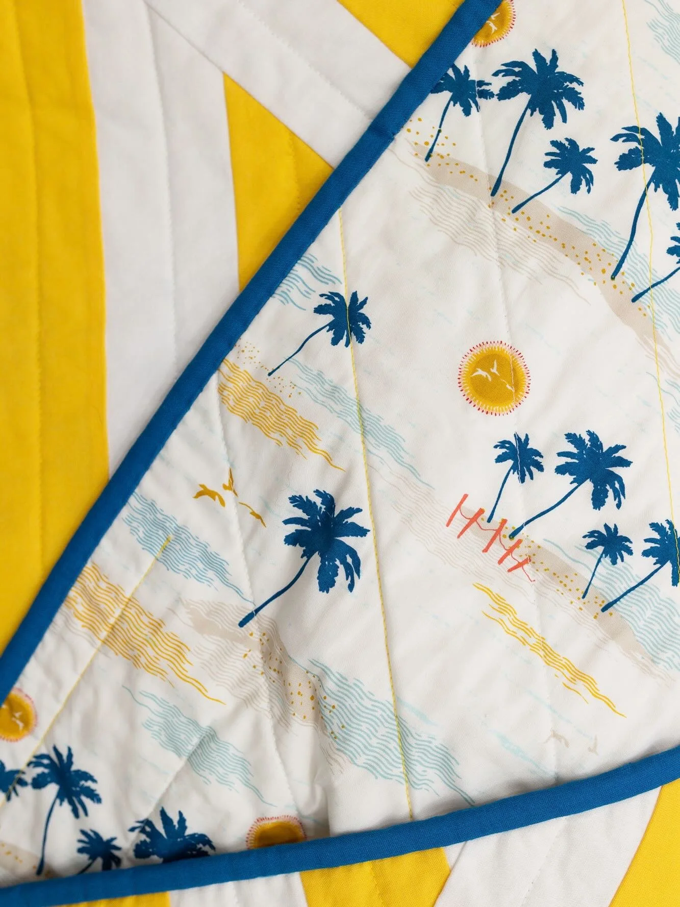 Keep warm while you dream of tropical beaches with this sunny yellow quilt available for sale in my shop. #stillwinterinvermont #capriquilt #modernquilter #handmade
