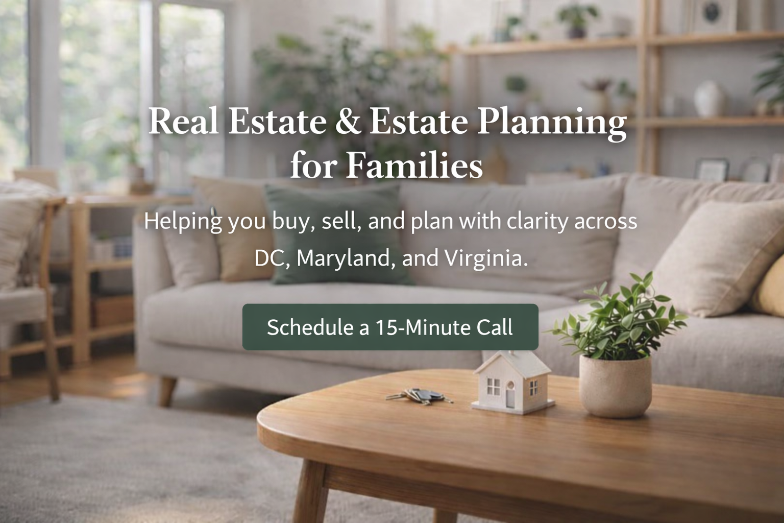 Living room with sofa, pillows, coffee table with house model, set for real estate and estate planning services for families in DC, Maryland, and Virginia.