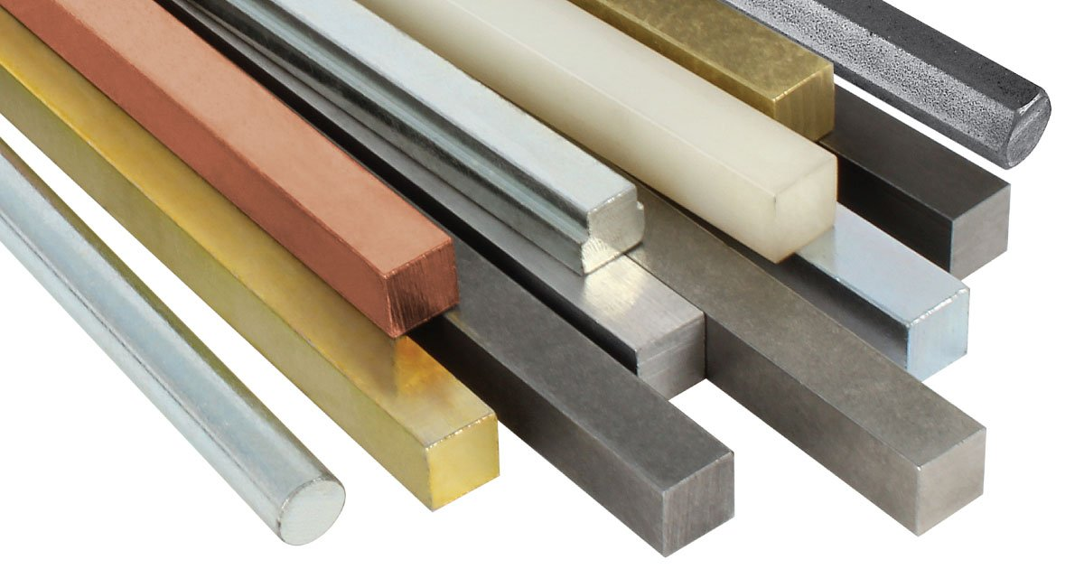 Various metal rods in different colors, including silver, gold, brass, copper, black, and white, arranged in a row.