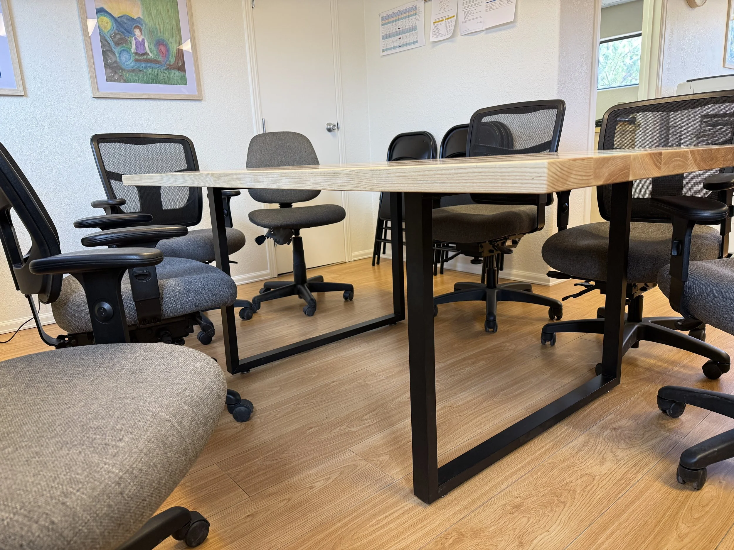 Large conference table with modern steel legs in black and square frame shape