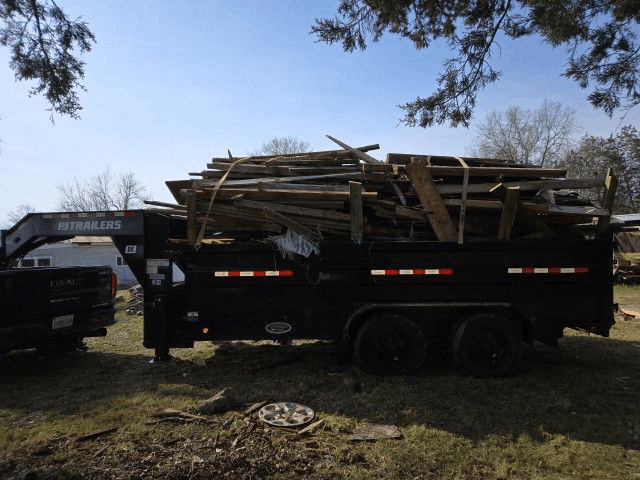 Trailer loaded with junk including old wood