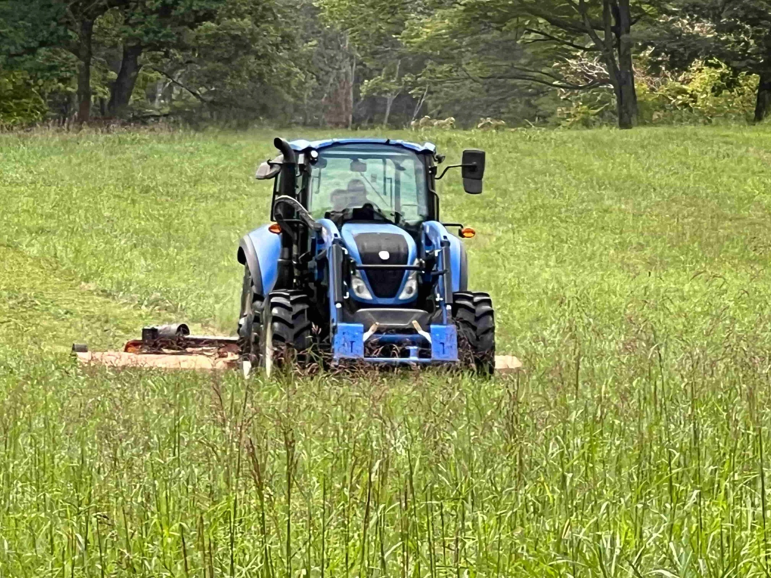 A tractor mowing a field