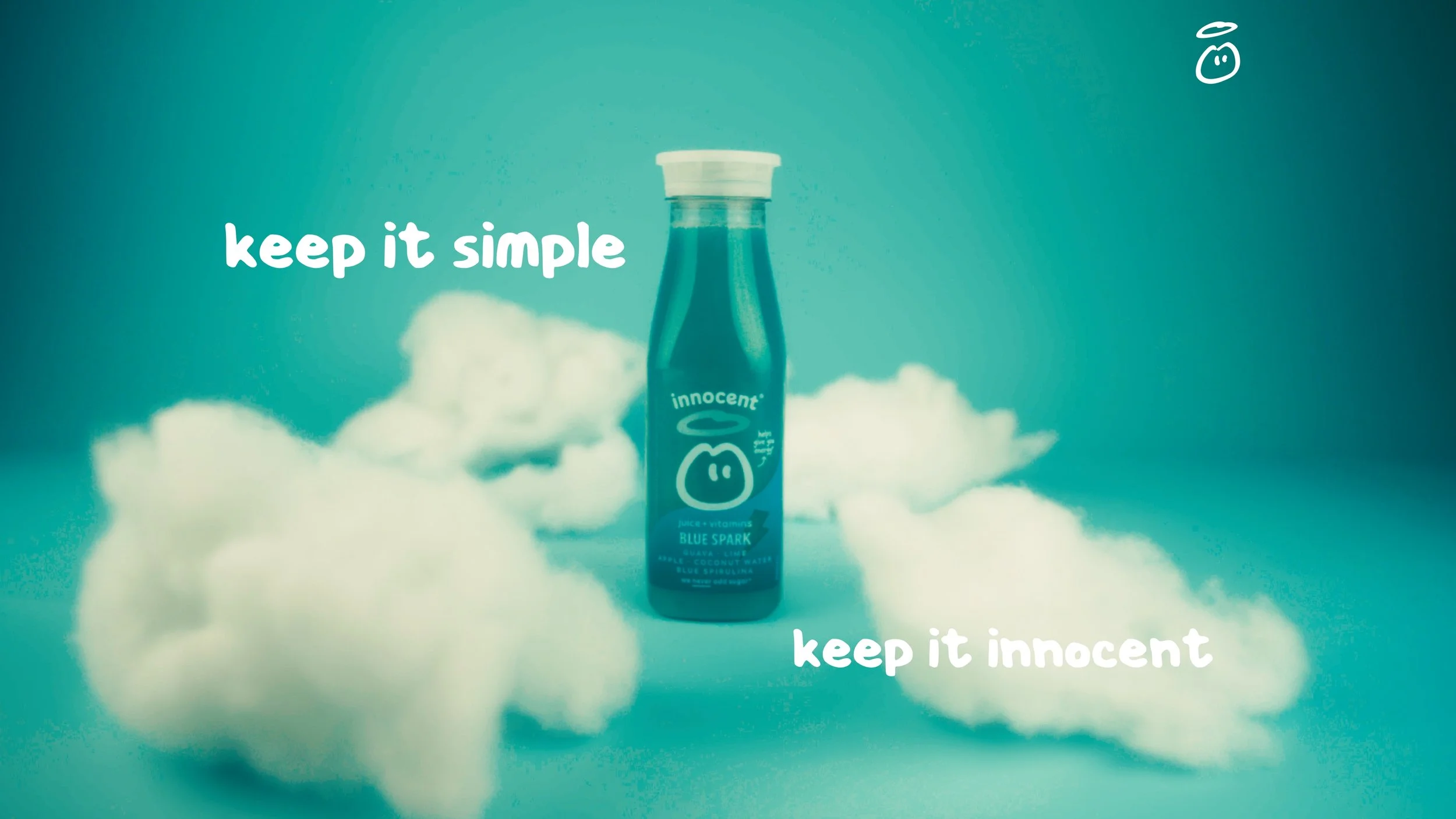 A bottle of Innocent Blue Spark juice with a background of clouds and a teal gradient sky, with text saying 'keep it simple' and 'keep it innocent'.