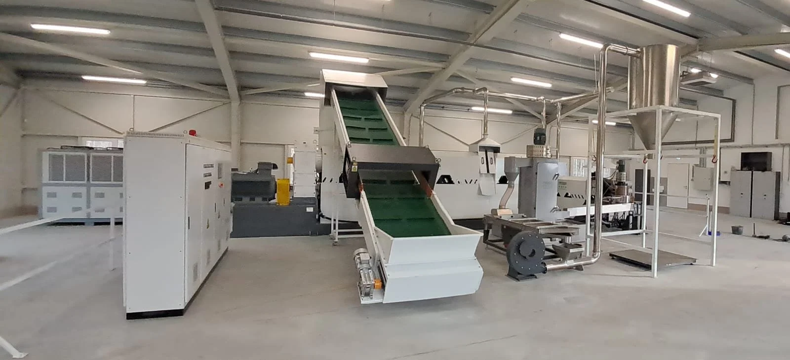 Industrial machinery inside a factory or manufacturing plant, including conveyor belts and processing equipment.