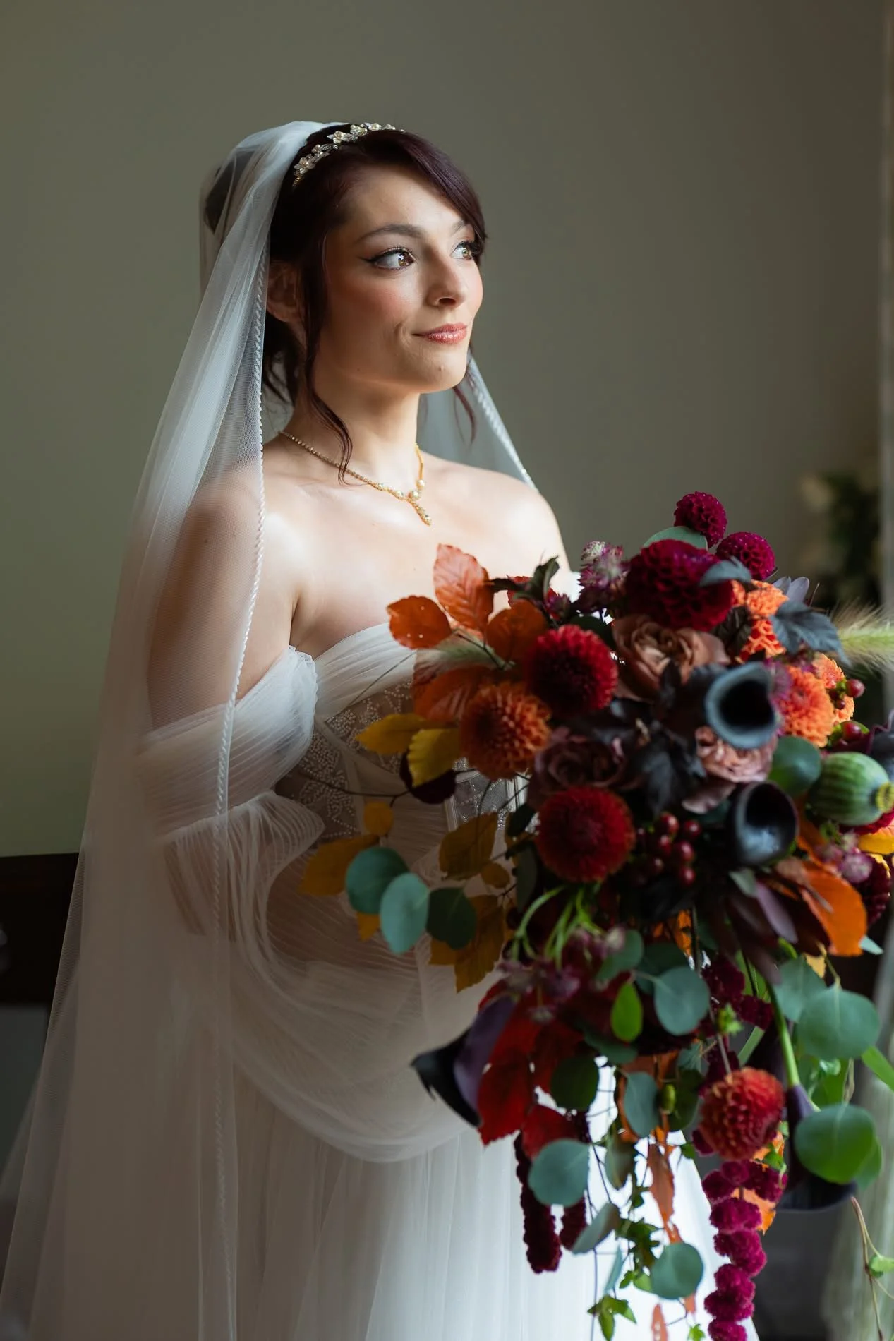 bride holding autumn bridal bouquet with rich moody wedding flowers by wild willow event design wedding florist northern ireland 