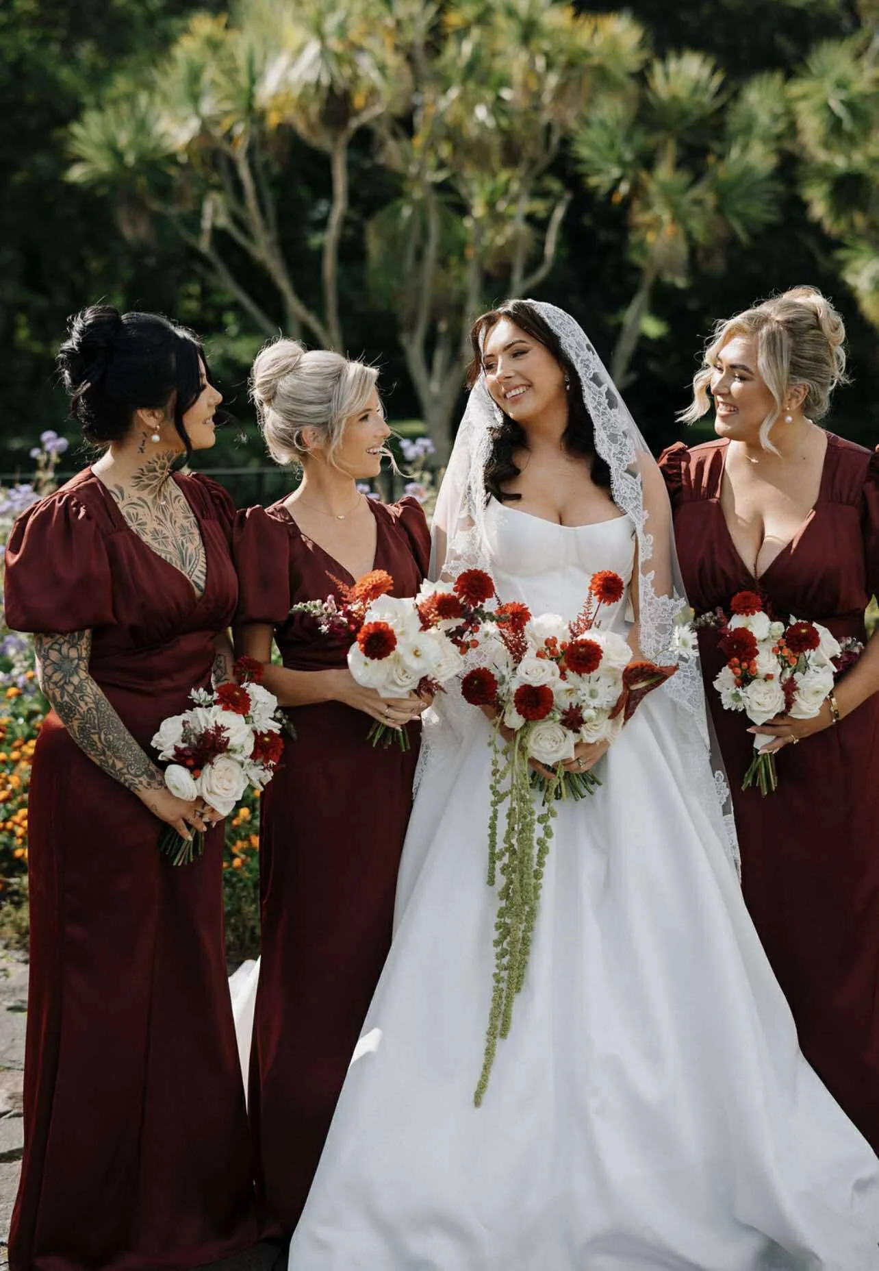 luxury fresh wedding flowers northern ireland, happy bride and bridal party holding fresh bouquets on northern irelands antrim coast