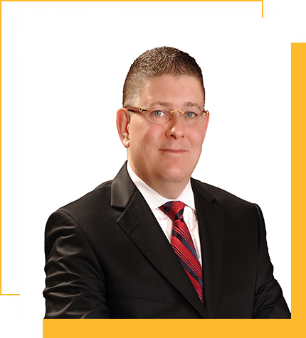 Professional man in a black suit with a white shirt and red striped tie, posing against a white background with yellow accent borders.