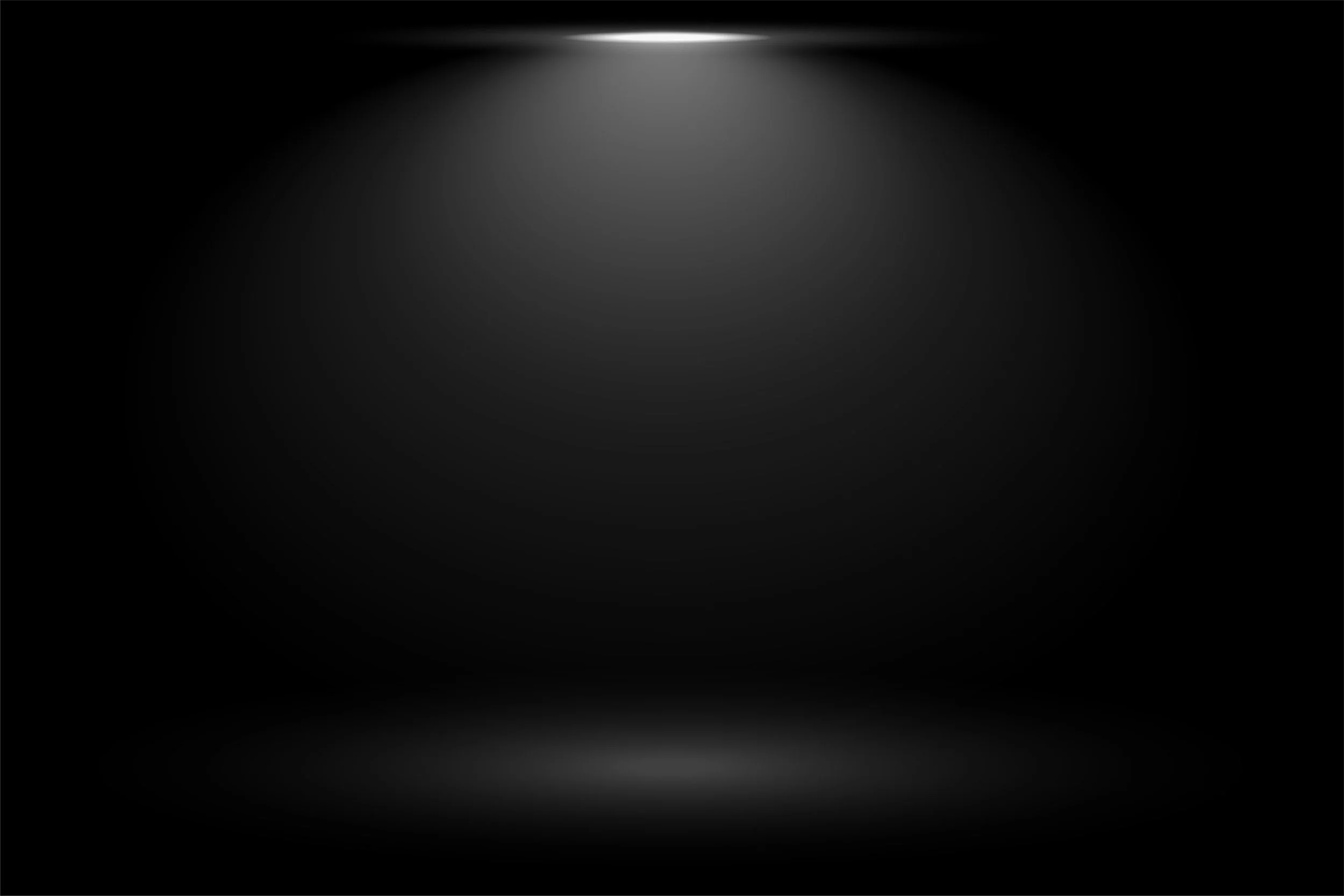 Dark background with a spotlight shining down, creating a faint illuminated area on the floor.