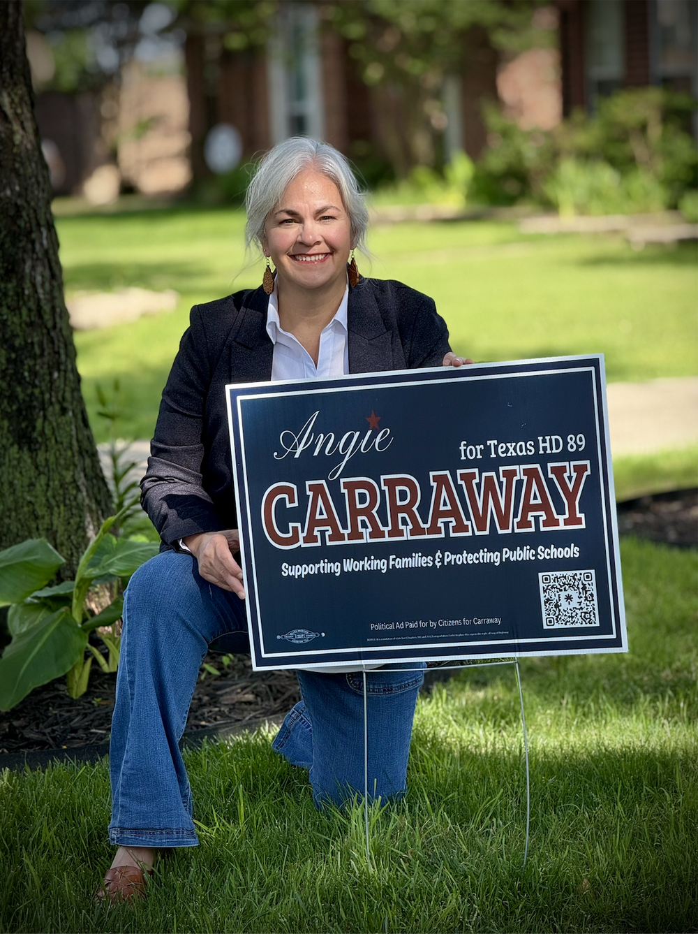 Angie Carraway with a campaign yard sign in a Collin County yard