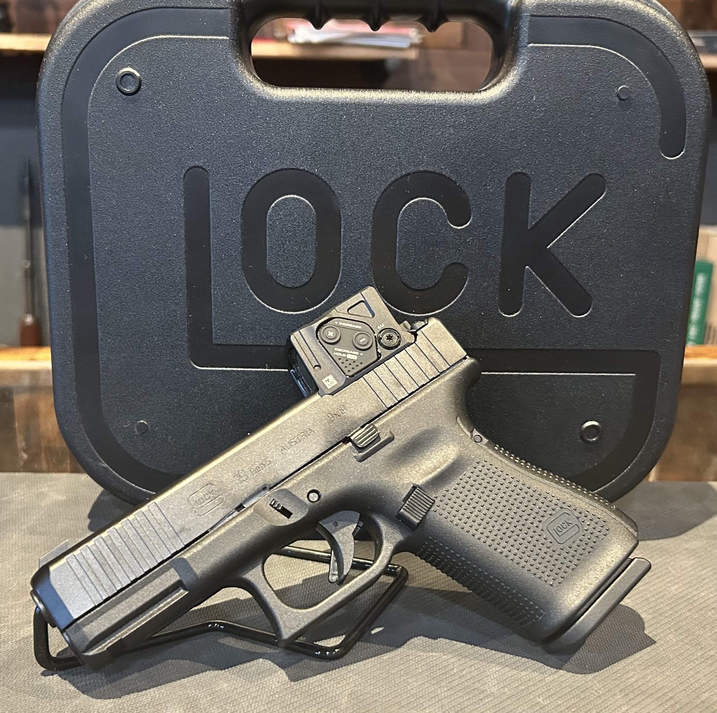 A Glock 19 Gen 5 with Aimpoint COA Red-Dot Sight