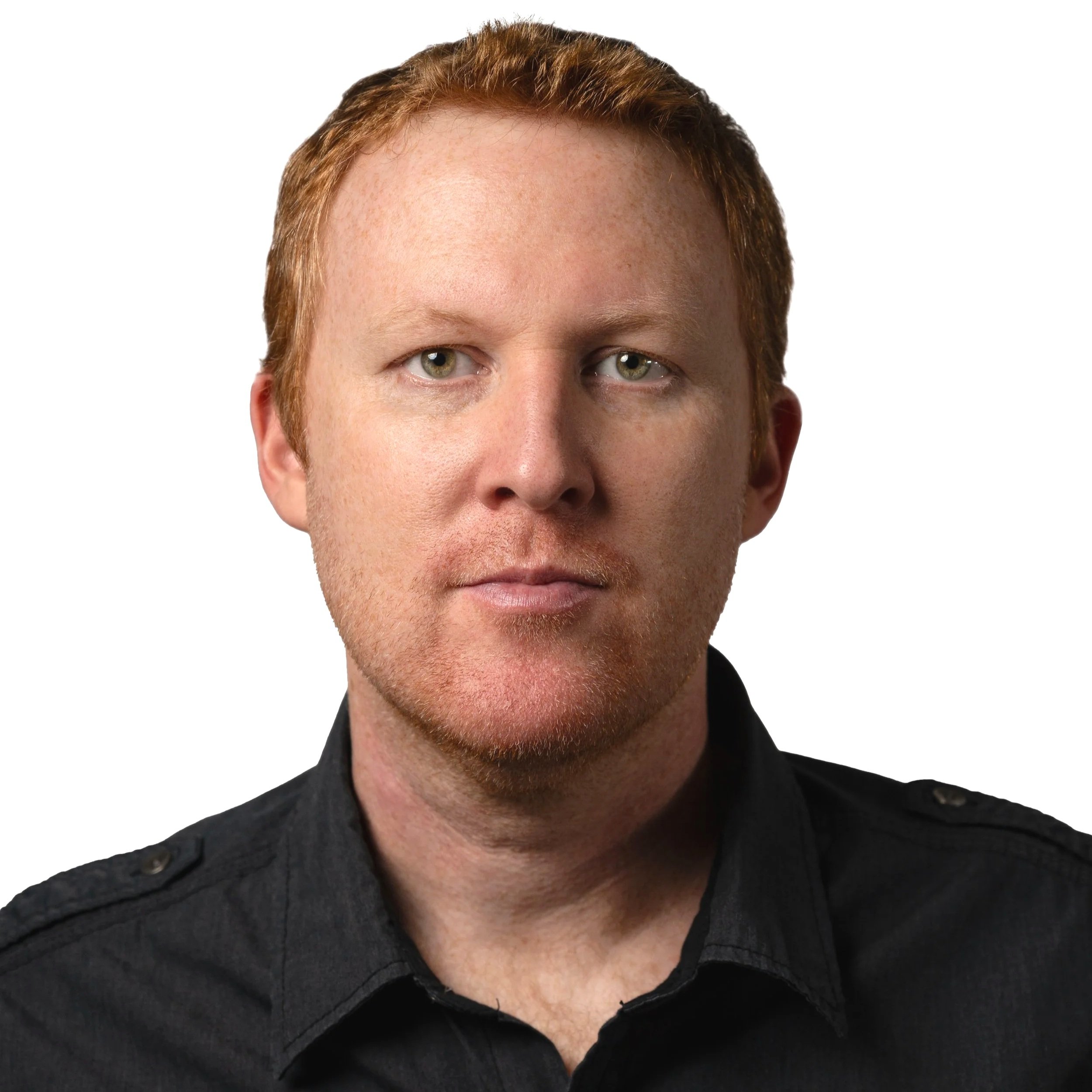Close-up portrait of a man with red hair and light skin, wearing a black shirt, against a white background.