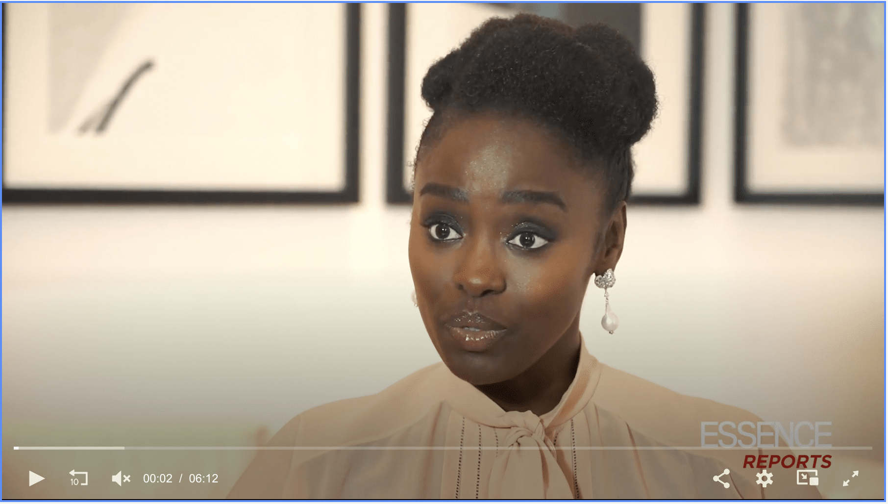 Essence Magazine: Aissa Maiga during an interview with Robin Allison Davis. The background features framed artwork on a white wall.