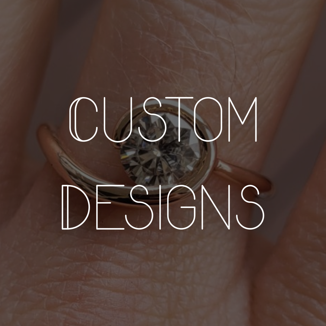 A close up picture of a rose gold and moissanite engagement ring on a hand. Text overlay reads custom designs.