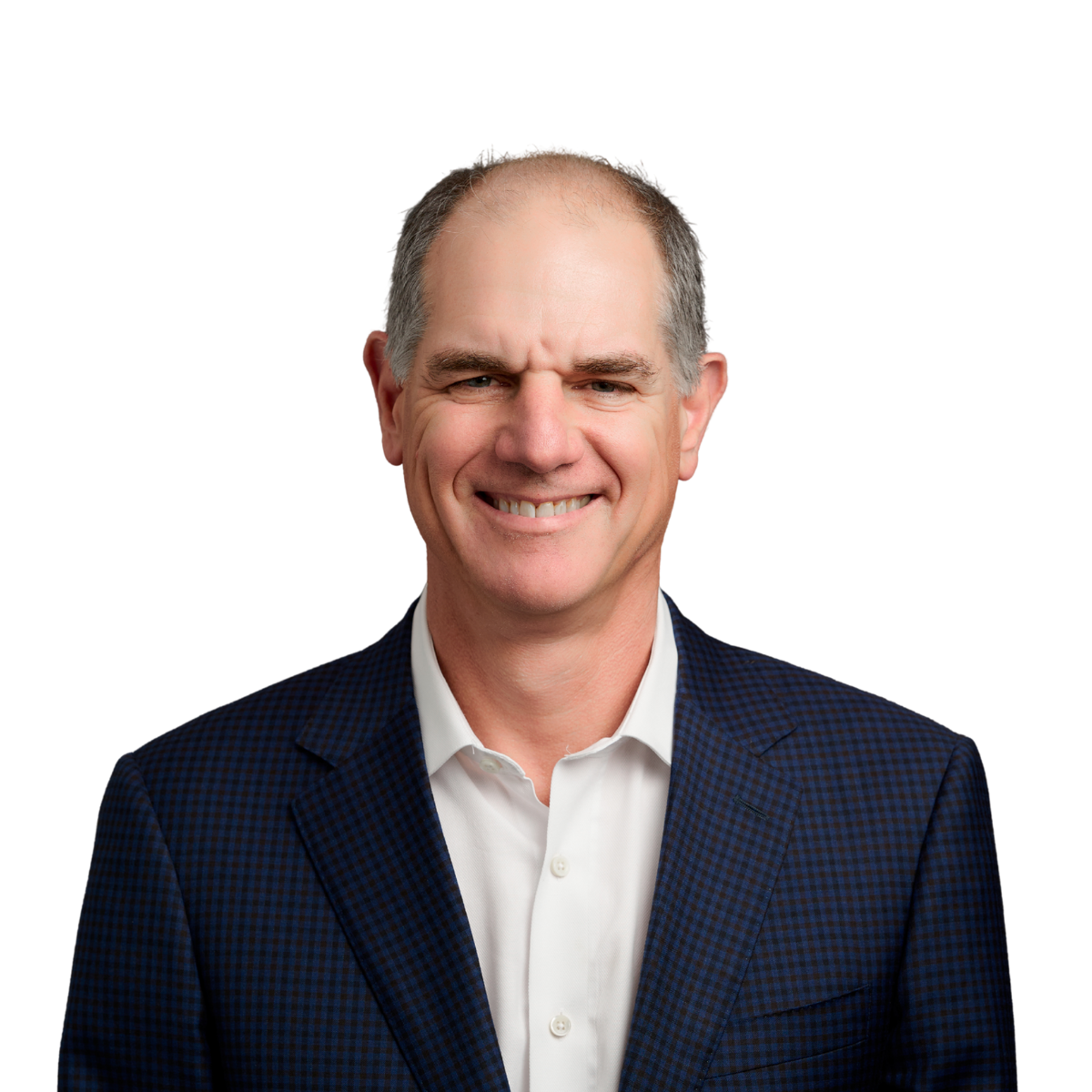 A smiling man wearing a white shirt and a dark checkered blazer, with short hair and a friendly expression.