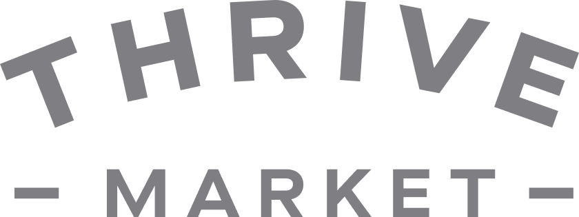 The image displays the logo of Thrive Market with the word 'THRIVE' in large capital letters, arched above the word 'MARKET' in smaller capital letters, and two horizontal lines on each side of 'MARKET'.