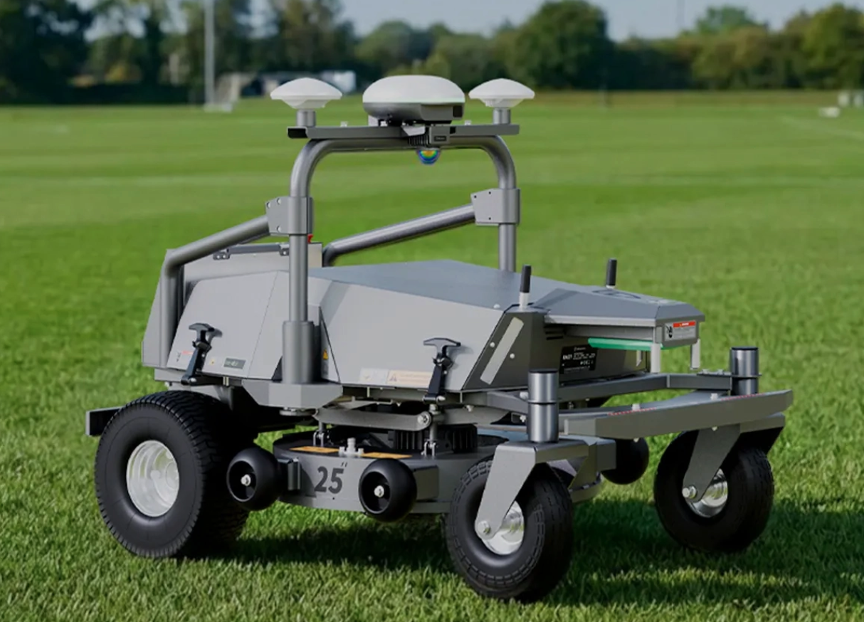 Autonomous robotic mower on a grassy field.