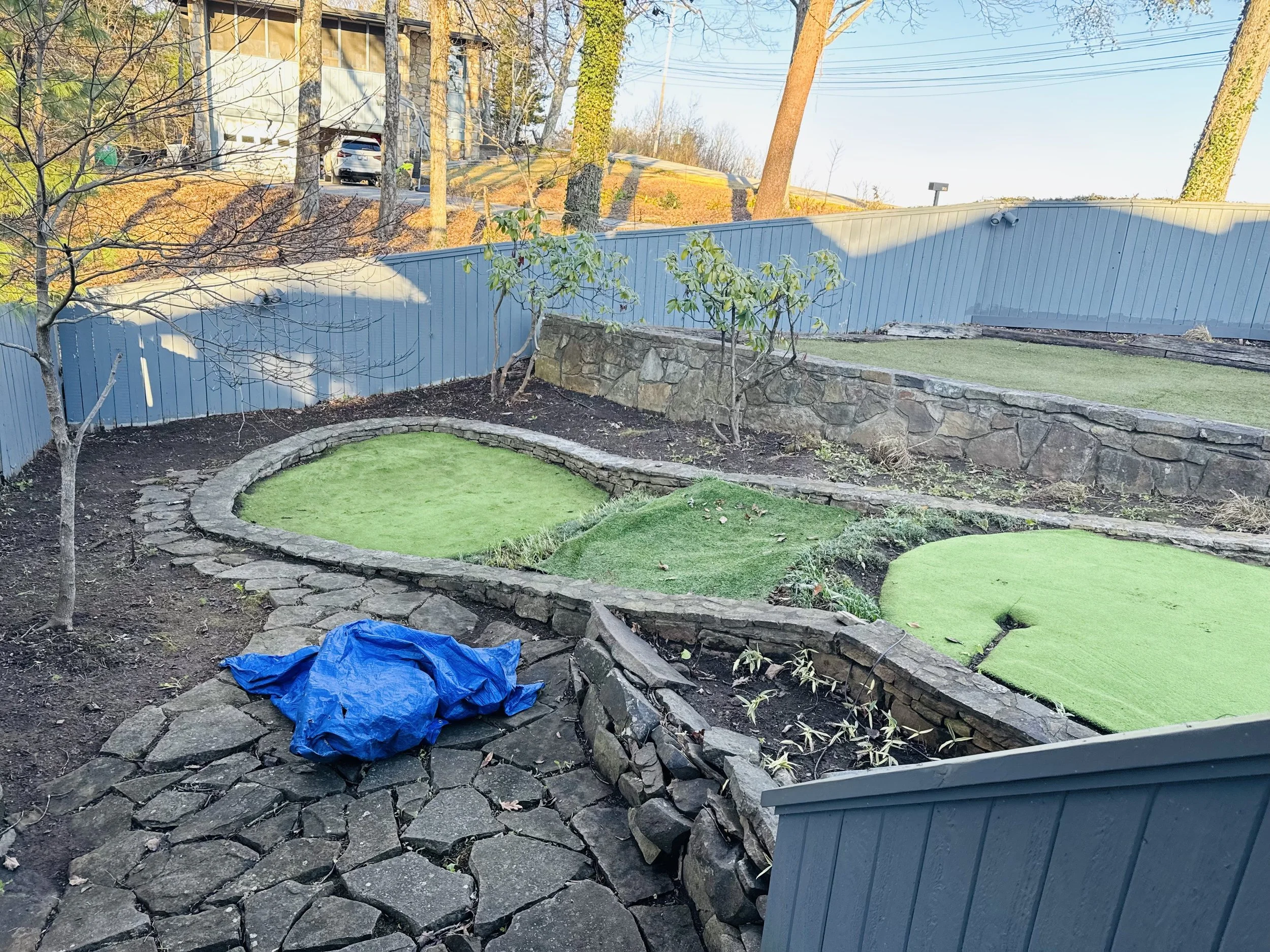 Tiered stone retaining wall and pathway providing structure, erosion control, and style.