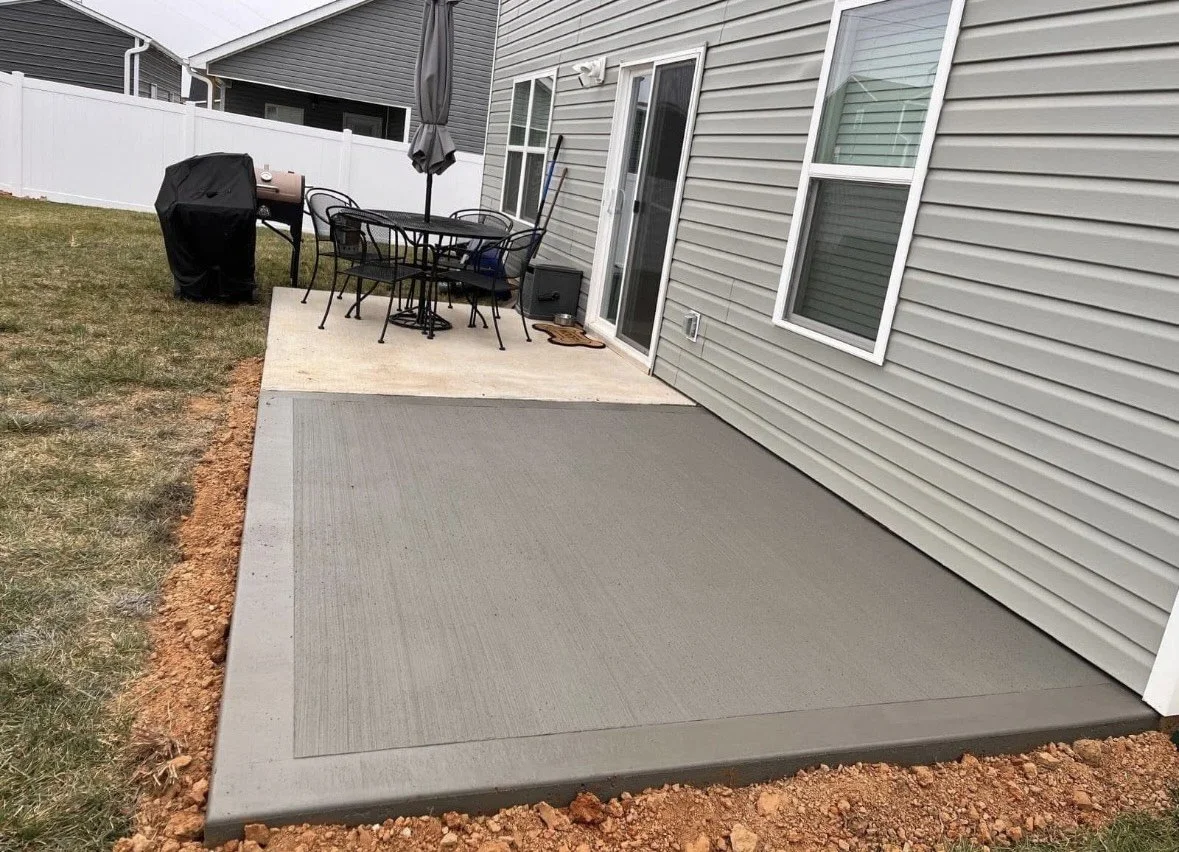 Concrete backyard patio designed for outdoor entertaining, grilling, and relaxation.