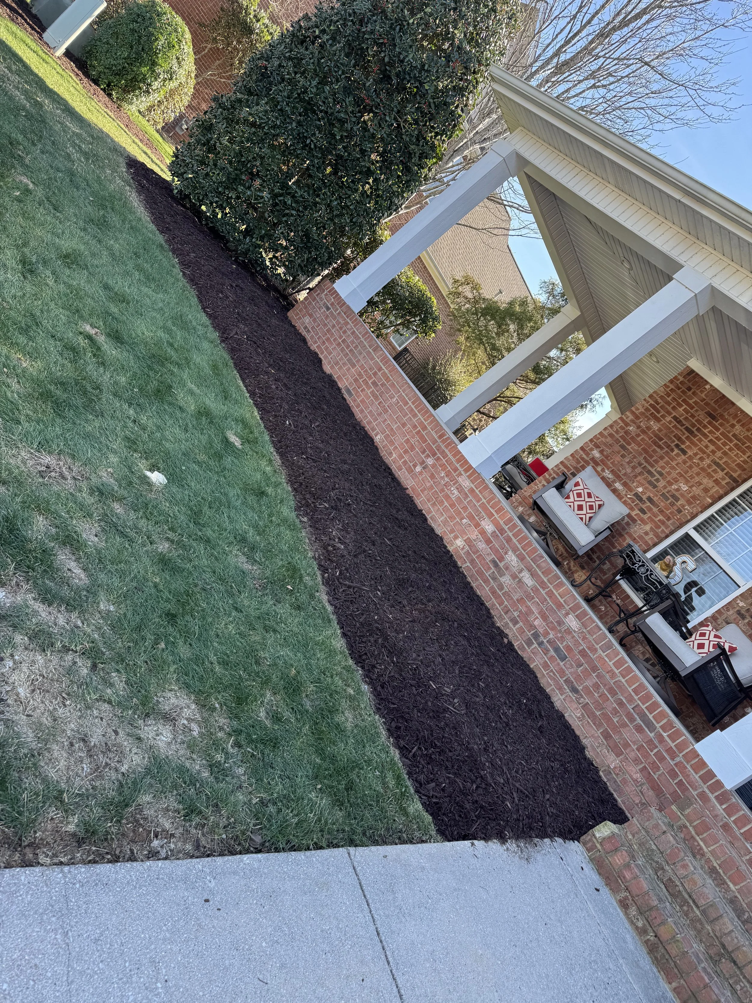 New mulch beds framing the home’s entrance for a clean, welcoming appearance.